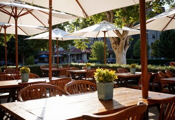 Obraz premium Elegant outdoor restaurant setting with shaded tables 