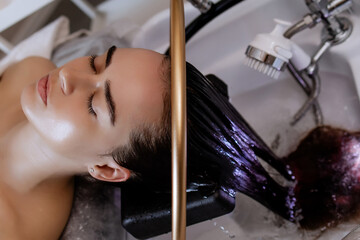 Close-up of a woman receiving a head massage during a Japanese head spa treatment with water...