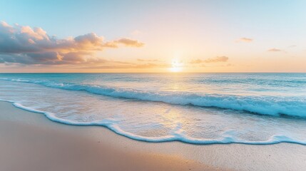Fototapeta premium Sunrise over calm ocean waves on sandy beach at dawn