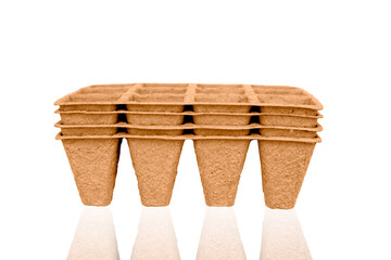 Stack of recycled compostable paper seedling trays, plant pots isolated on white background with clipping path.