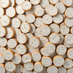 Lot of slices lot of pieces of bavarian white sausage isolated on white