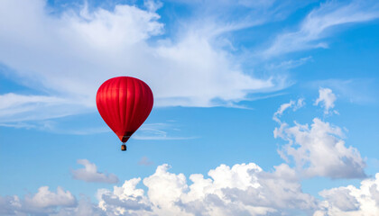 Obraz premium red balloon floats gracefully in clear blue sky, surrounded by fluffy white clouds, creating serene and uplifting atmosphere