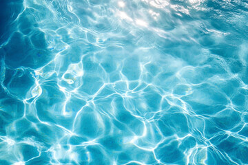 Above view of swimming pool water waves with sunlight reflections and caustic patterns on blue surface