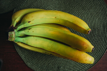 Fresh Ripe Bananas on a Dark Table – Close Up of Tropical Fruit Bunch