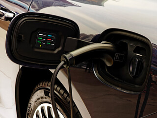 closeup view of EV car charing wth information displayed.
