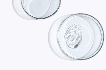 Skin serum or face wash gel in a Petri dish. For cosmetic procedures. White background