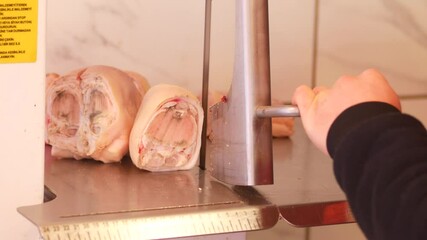 Cutting fresh meat at a local butcher shop in the morning
