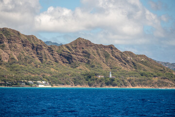 Fototapeta premium Close view of Diamond Head’s rugged crater face with forested slope and beach below, captured March 15, 2019 in Honolulu, Hawaii, USA