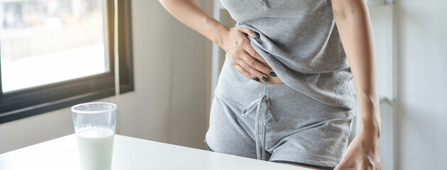 lactose intolerance concept. Woman touching her belly and having a stomach pain.