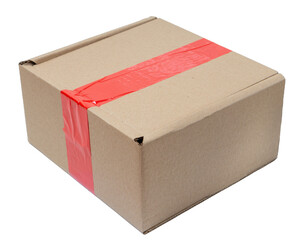 Isolated corrugated cardboard box with red sticky tape on white background