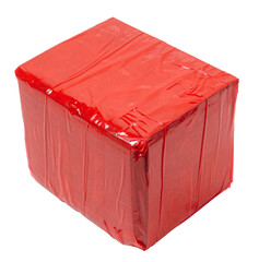 Isolated corrugated cardboard box covered with red sticky tape on a white background