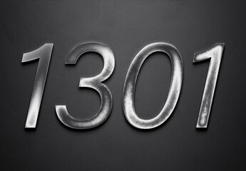 Chrome metal 3D number design of 1301 on grey background.