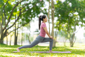 Fototapeta premium Woman Stretching Outdoors in Park