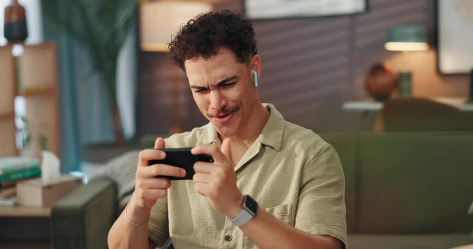 Man, phone and earphones for video on sofa with movie surprise, streaming subscription and online channel. Relax, person and smartphone in home for web entertainment, internet show or watching series