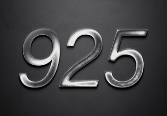 Chrome metal 3D number design of 925 on grey background.