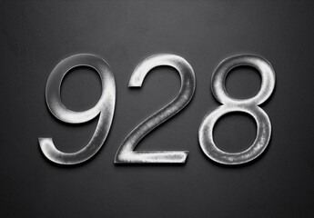 Chrome metal 3D number design of 928 on grey background.