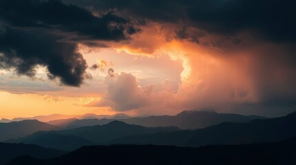 Layers of shadowy mountains contrasted by dramatic, fiery clouds in a colorful, scenic vista.