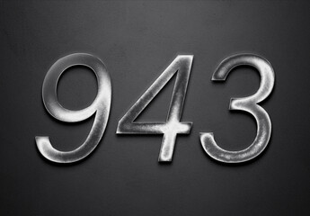 Chrome metal 3D number design of 943 on grey background.