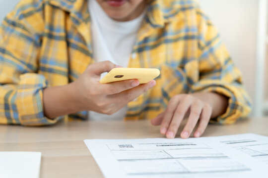 Modern woman use phone to scan barcode or QR codes to pay credit card bill after receive document invoice. payment, receive, paying electricity, digital payments without money, technology, scanning
