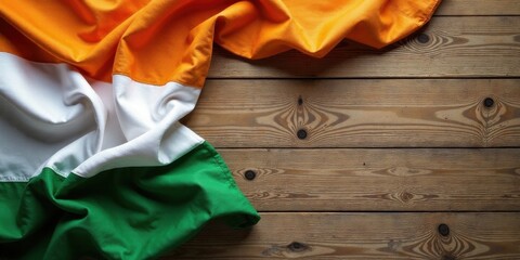 A vibrant tricolor fabric draped elegantly on a rustic wooden surface