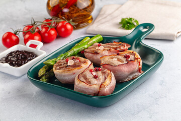 Tasty grilled pork medallion with bacon