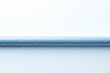 A horizontally-oriented close-up showcasing a light-blue cylindrical object, meticulously detailed with minute droplets adhering to its surface against a stark white backdrop