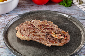 Grilled lamb steak with bone