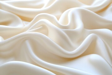 Obraz premium Soft, flowing cream-colored fabric with gentle folds and ripples creates a smooth, elegant textile surface