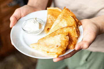 Plate of Freshly Made Crepes with Sour Cream