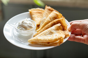 Pancakes Dipped in Cream Close-Up on Plate