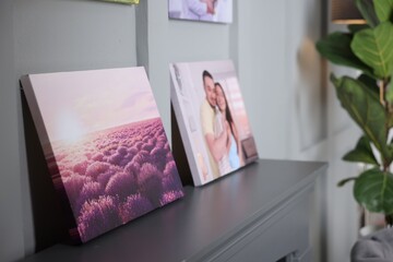 Canvas with printed photos on table indoors