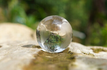 Glass globe placed on moss. Environmental concept. Concept of society and governance regarding a sustainable global environment.