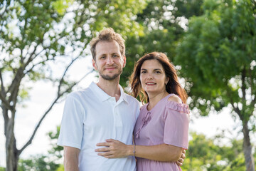 Young lovers walk hand in hand in the park Romanticly. On a relaxing holiday