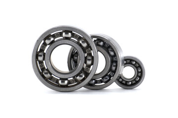 Various sized ball bearings neatly arranged against a plain white backdrop, showcasing engineering design.