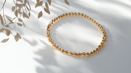 Gold beaded bracelet on white background