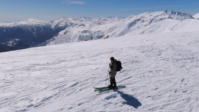Skimo - Mountaineer Walking With Ski And Poles In The Snowy Caucasian Mountains, Georgia. - aeria shot