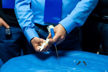 Surgical technique training demo. Surgeons practice suturing techniques during a training session,...