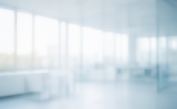 Blurred empty office space with large windows and bright light. - Powered by Adobe