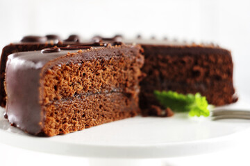 Chocolate Sacher torte on white background. Selective focus.
