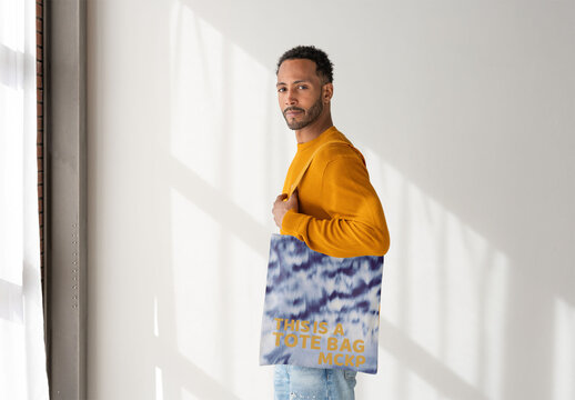 Man With Tote Bag in Chic Space. PSD template ready for Mockup