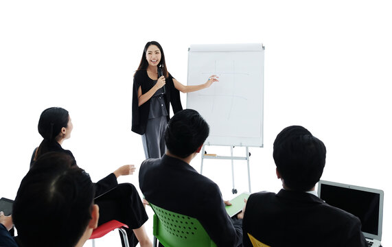 Professional Asian business leader woman presenting financial sales reports on white paper board to diverse team of colleagues. business people seminar for marketing research