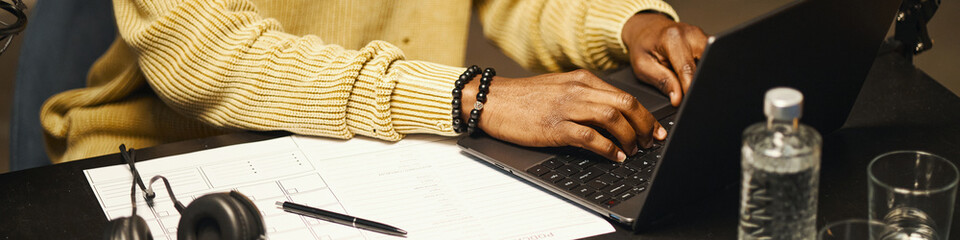 Header with man working online on laptop in studio