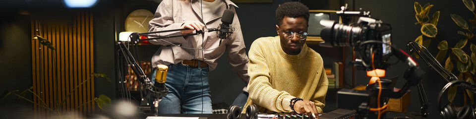 Header with colleagues recording online podcast in studio