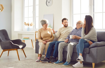 Happy family talk of multi generational relative people at home, mature woman, man close to elderly...