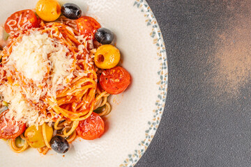 delicious classic tomato sauce and basil spaghetti, italian pasta on a dark background. top view. copy space