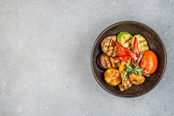 Grilled vegetables in plate colorful bell pepper, zucchini, eggplant on a light background. top view. copy space for text