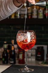 Aperol spritz cocktail in a glass with ice and orange, minimal trendy shot. Alcohol aperol spritz aperetivo