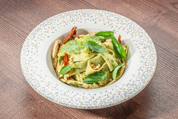 Tagliatelle pasta with pesto, chicken and Parmesan, top view