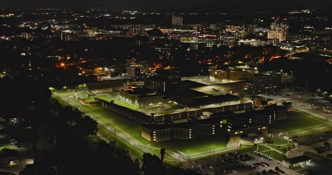 Raleigh North Carolina Aerial v57 birds eye view flyover Dix Park capturing the fortified perimeter of Central Prison and Glenwood South cityscape at night - Shot with Inspire 3 8k - Sept 30th 2023