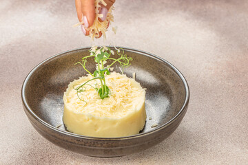 mashed potatoes with Parmesan cheese on light background. Top view, copy space